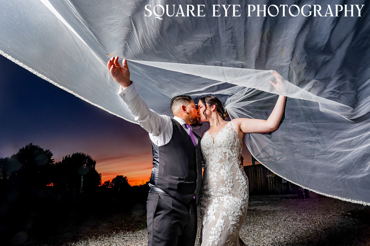 cathedral-veil-sunset-wedding-photos.jpg-02 Cathedral veil wedding photos of a bride with her long veil lifted against the sunset, photographed by Square Eye Photography